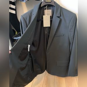 “The Italian Wool Suit Jacket” from Everlane. Size 40r, brand new, charcoal